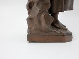 bronze statue of a woman with a dog on a white background