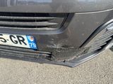 the front bumper of a car with a number plate on it ' s bumper