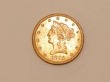 a close up of a gold coin with a woman ' s head on it