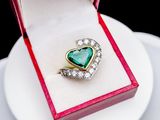 an image of a heart shaped ring in a box on a plate