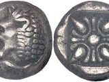 a close up of a coin with a flower design on it