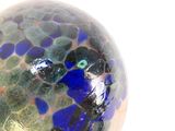 a glass vase with a blue and green design on it