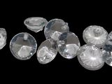 several pieces of clear crystal sitting on top of a black surface