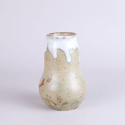 a small vase that has a white substance on it