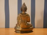 a statue of a buddha sitting on a table