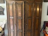 a large wooden cabinet with a pot on top of it