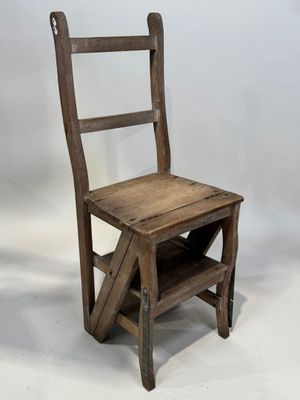 an old wooden chair sitting on top of a white floor