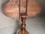 une petite table en bois avec un plateau en bois, posée sur un sol carrelé