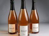 three bottles of wine sitting next to each other on a table