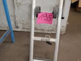 a ladder that has a sign on it in front of a door