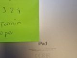 a post it note attached to the back of an apple laptop