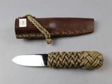 a knife that is sitting next to a knife sheath