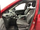 the interior of a red car with the door open and the driver ' s seat down