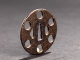 a metal object with holes on it on a table