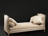 an image of a day bed with pillows on it