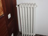 a radiator in the corner of a room next to a door
