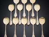 a set of eight silver spoons with portraits of people on them