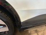 a close up of a white car with a black door handle