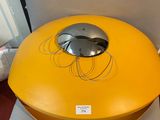 a large yellow bowl with a metal lid on a table