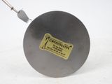 a close up of a frying pan on a white surface