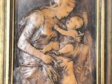 painting of a woman holding a baby in a gold frame