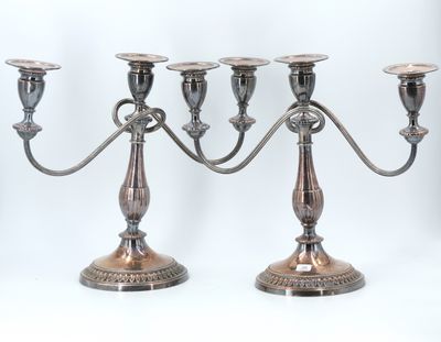three silver candlesticks on a white background