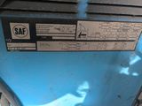 a close up of a blue machine with a hand on it