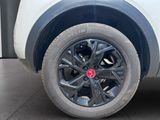 a close up of a tire on a white car