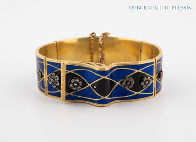 an image of a gold bracelet with blue enamel and diamonds