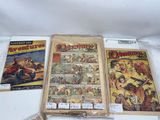 three comics are on display on a white surface