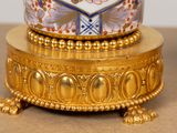 a gold plate with a white and blue design on it