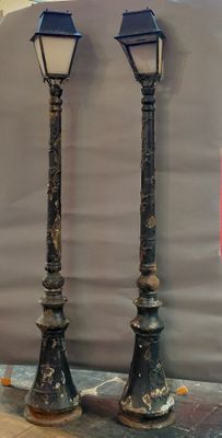 two street lamps that are standing on a table