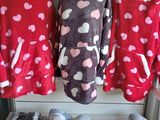 three women ' s pajamas are on display at a clothing store