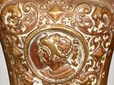 a brown vase with a picture of a horse on it