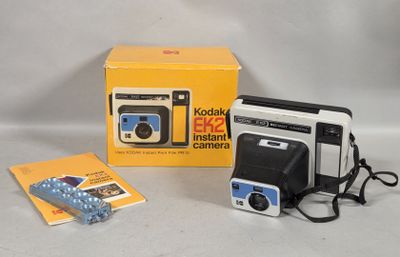 a small camera and a book on the table