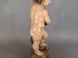 statue of a small child on a pedestal with a gray background