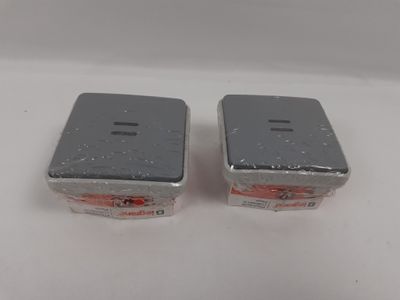 two salt and pepper shakers sitting on a white surface