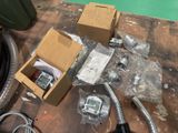 a box of electronic equipment on the floor next to a box of wires