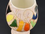 a white vase with a multicolored design on it