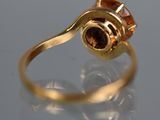 an image of a gold ring with a brown stone in the center