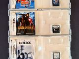 three nintendo games in a clear case on a table