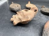 several pieces of pottery sitting on top of a table next to a pair of scissors