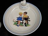 a plate with a picture of a boy and a girl sitting on a bench