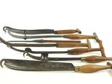 several different types of knives are lined up on a white surface