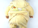 a baby doll that is laying down on the floor