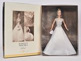 une image représentant une poupée Barbie dans une boîte, sur laquelle figure la photo d'une femme en robe de mariée