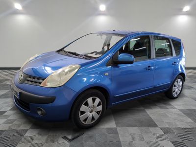 a blue car is parked in a room with a checkered floor