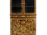 a black and gold painted cabinet with glass doors
