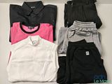 three pairs of black, white, pink and grey clothing laid out on a table