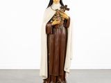 a statue of a woman holding a cross in her hands